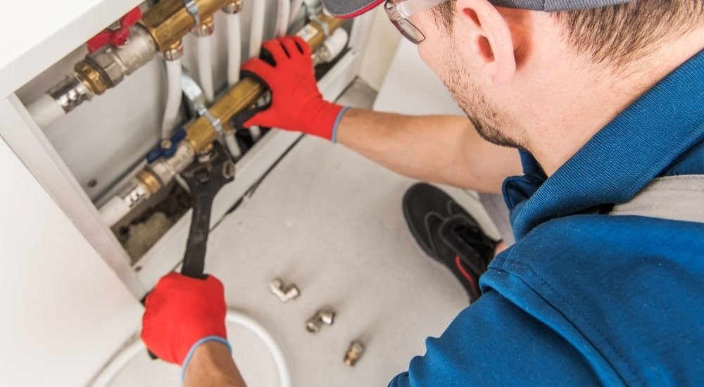 plumber working on pipes